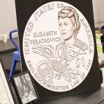 The design for the new gold $1 Elizabeth Peratrovich coin was on display during the Elizabeth Peratrovich Day celebration at the Tlingit and Haida Community Council Sunday. (Michael S. Lockett | Juneau Empire)