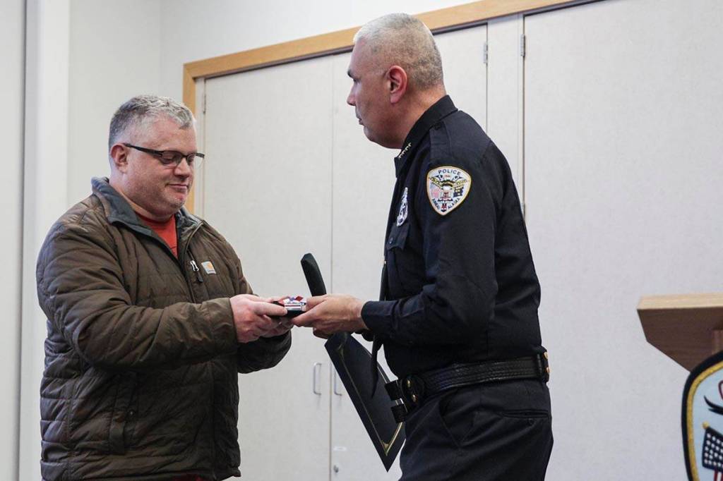 Retired Officer Jason Van Sickle of the Juneau Police Department was awarded the Medal of Bravery by Chief Ed Mercer on Tuesday. (Michael S. Lockett | Juneau Empire)