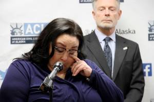 Clarice Hardy wipes a tear away from her eye during a news conference Thursday in Anchorage. The American Civil Liberties Union of Alaska filed a lawsuit Thursday on Hardys behalf against the City of Nome and two former officers for failing to investigate the sexual assault report filed by Hardy, a former police dispatcher. On the right is Stephen Koteff, the ACLUs legal director in Alaska. (AP Photo | Mark Thiessen)