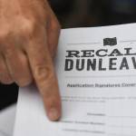 Juneau residents lined up outside of the Planet Alaska Gallery to sign an application petition to recall Gov. Mike Dunleavy in August 2019. Signatures are again being collected. (Michael Penn | Juneau Empire File)