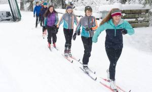 Juneau Nordic Ski Team members Erin Wallace, front, leads Aaron Blust and Anna Iverson in a pole-less skiing drill through fresh snow on Saturday, Nov. 18, 2017, at the Mendenhall Campgrounds. (Nolin Ainsworth | Juneau Empire File)