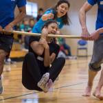 Trinity Jackson, 13, participates in the wrist carry as judge Elizabeth Rexford watches at the Native Youth Olympics 2018 Traditional Games at the University of Alaska Southeast Recreational Center in March 2018. Tuckwood won the event for middle school students. (Michael Penn | Juneau Empire File)