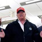 President Donald Trump speaks to members of the press as Health and Human Services Secretary Alex Azar, left, and CDC Director Robert Redfield, right, at the headquarters of the Centers for Disease Control and Prevention in Atlanta on Friday, March 6, 2020. (Hyosub Shin/Atlanta Journal-Constitution via AP)