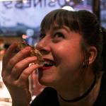 Bonilyn Parker shoots an oyster at the Triangle Club on First Friday.