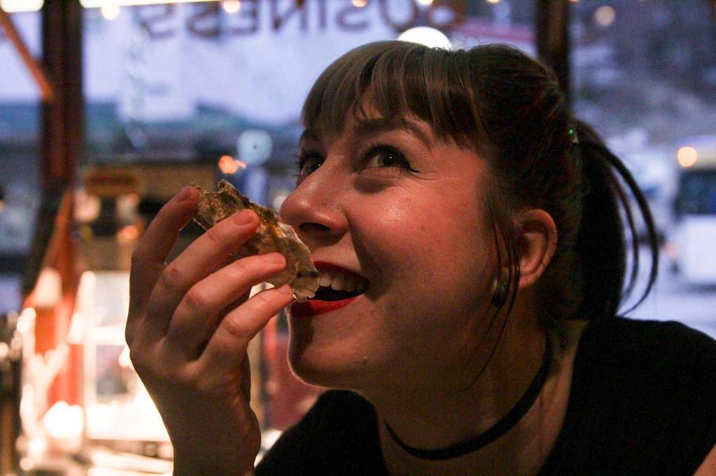 Bonilyn Parker shoots an oyster at the Triangle Club on First Friday.