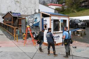 Dave McCasland, owner of Deckhand Daves Fish Tacos, center, talks with Eric Plummer, left, and Brennen Brewer, of Peak Construction, as they set up food truck businesses at Gunakedeit Park, also known as Pocket Park, on Thursday, May 9, 2019. (Michael Penn | Juneau Empire)