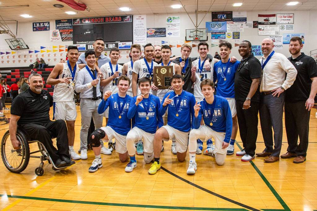 Thunder Mountain High School boys basketball coaches and players hold their medals and plaque after winning the Region V 4A championship. (Courtesy Photo | Heather Holt)