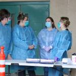 Ben Hohenstatt | Juneau Empire                                 Southeast Alaska Regional Health Consortium employees talk outside the organizations executive offices in Juneau as they await patients for drive-through COVID-19 screening on Friday.