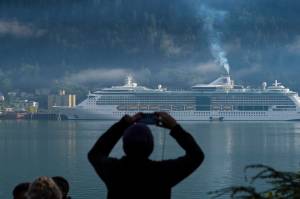 Aa cruise ship passenger photographs a ship in Juneaus downtown harbor in August 2017. (Michal Penn | Juneau Empire File)