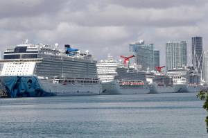 Cruise ships are docked at PortMiami, Tuesday, March 31, 2020, in Miami. The U.S. Coast Guard said Tuesday that its working with Holland America on a detailed docking plan that would require two ships carrying passengers and crew from an ill-fated cruise to handle all medical issues without impacting South Floridas already-stressed hospitals. (AP Photo/Wilfredo Lee)