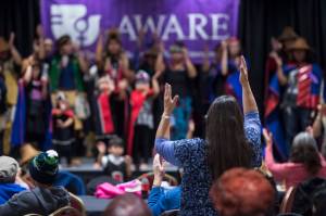 People pay tribute to the Woosh.ji.een Dance Group as they perform during a Celebrate Survivors gathering sponsored by Central Council Tlingit and Haida Indian Tribes of Alaska and AWARE in the Elizabeth Peratrovich Hall in 2018. (Michael Penn | Juneau Empire File)