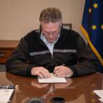 Gov. Mike Dunleavy signs the Fiscal Year 2021 budget into law in Anchorage on Monday, April 6, 2020. (Courtesy photo | Office of Gov. Mike Dunleavy)