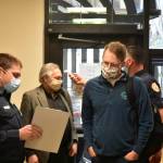 Rep. Lance Pruitt, R-Anchorage, answers screening questions upon entering the Capitol building. Behind him Rep. Dave Talerico, R-Healy, gets his temperature taken on Monday, May 18, 2020. (Peter Segall | Juneau Empire)