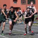 Aaron Blust takes a handoff from teammate Owen Squires during a 2019 track meet in Haines. (Courtesy Photo | For JDHS Track & Field)