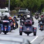 Members of the Southeast Alaska Tongass chapter of the Harley Owners Group head down Glacier Avenue past Juneau-Douglas High School: Yadaa.at Kalé on their way to Evergreen Cemetery for a moment of silence for deceased U.S. military members on Monday, May 25, 2020. (Peter Segall | Juneau Empire)