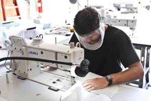 Gabe Donohoe, lead sewer, works on creating face shields for people with hearing loss. Rapid Response PPE, founded at the beginning of the coronavirus epidemic, is creating specialized PPE, allowing people with hearing loss or dead people to easily see the speakers face, May 29, 2020. (Michael S. Lockett | Juneau Empire)