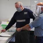 Carl Ferlauto, left, and Hal Daugherty discuss the design for their face shield for people with hearing loss. Rapid Response PPE, founded at the beginning of the coronavirus epidemic, is creating specialized PPE, allowing people with hearing loss or deaf people to easily see the speakers face, May 29, 2020. (Michael S. Lockett | Juneau Empire)