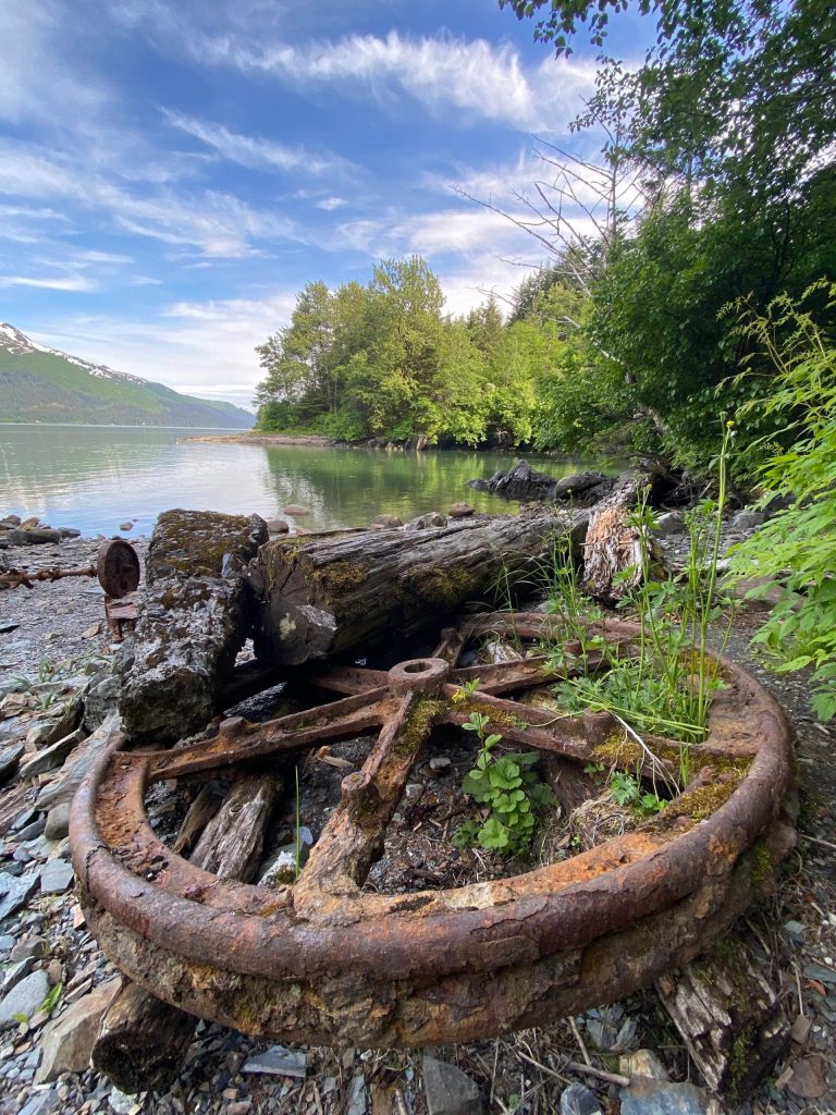 An iron wheel relic can be seen on a beach at Treadwell Cave In cove, Douglas. (Courtesy Photo | Kenneth Gill, gillfoto)