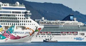 A fishing vessel is drawfed by the Norwegian Cruise Lines Norwegian Jewel and Norwegian Pearl in Juneaus downtown harbor in September 2014. (Michael Penn | Juneau Empire File)