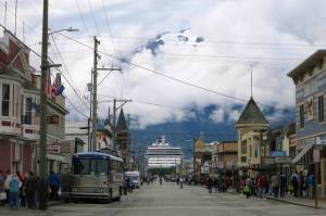 This July 2014 photo shows a cruise ship docked in Skagway, Alaska, as passengers tour the town. The Alaska port city, nearly entirely dependent upon cruise ship tourism, wants to share its federal coronavirus relief funds with workers in town. The city of Skagway posted an application on its website inviting residents to apply for up to $1,000 in relief funds to help with bills. Nearly half of Alaskas 2.2 million tourists arrive on cruise ships, but most companies have canceled their summer seasons, leaving workers here without much relief. (AP Photo | Kathy Matheson)