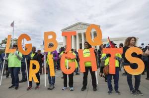 Supporters of LGBTQ+ rights hold placards in front of the U.S. Supreme Court in Washington on Oct. 8, 2019. The Supreme Court ruled Monday that a landmark civil rights law protects gay, lesbian and transgender people from discrimination in employment. Its a resounding victory for LGBTQ+ rights from a conservative court. (AP Photo | Manuel Balce Ceneta, File)