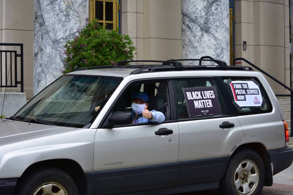 A caravan of union workers and their supporters drive through downtown Juneau on Wednesday, June 17, 2020, as part of a nation protest in support of workers during the COVID-19 pandemic. (Peter Segall | Juneau Empire)