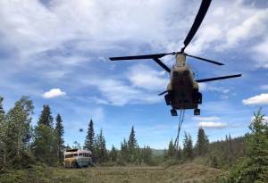 Alaska Army National Guard Soldiers assigned to 1st Battalion, 207th Aviation Regiment execute an extraction mission via a CH-47 Chinook helicopter over Healy, Alaska, June 18, 2020. As part of a combined effort with the Department of Natural Resources, the Guardsmen rigged and airlifted Bus 142, known from book and film, Into the Wild, out of its location on Stampede Road in light of public safety concerns. (Courtesy photo | Alaska National Guard )