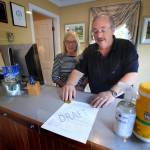 In this Wednesday, June 10, 2020, photo, Cod Cove Inn owners Ted and Jill Hugger show a draft of a compliance form that inn owners may be required to have out-of-state guests sign before being allowed to check in at their inn in Edgecomb, Maine. The form is part of the Keep Maine Healthy plan the state is proposing to help prevent the spread of the coronavirus. Residents of New Hampshire and Vermont would be exempt. (AP Photo | Robert F. Bukaty)