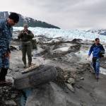 Navy Lt. Commander Paul Cocker (left), Alaskan Command deputy chief of future operations and Operation Colony Glacier project officer, shows local media some of the aircraft debris from the 1952 C-124 Globemaster II aircraft accident June 10. (U.S. Air Force photo | Tech. Sgt. John Gordinier)