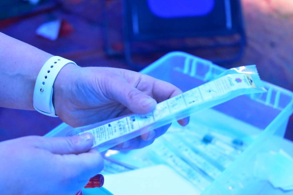 Capital City Fire/Rescue firefighter/paramedic Wendy Wallers holds up a testing kit at the citys drive-through Covid-19 testing site at the William A. Hagevig Regional Fire Training Center on Monday, June 29, 2020. (Peter Segall | Juneau Empire)