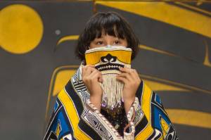 Elizabeth Hope holds up the Chilkat Protector Mask at a ceremony. (Courtesy Photo | Sydney Akagi Photography for Lily Hope)