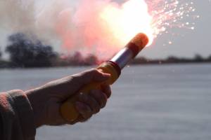 A signal flare burns bright enough to light up the day lit shores of the Sacramento Delta during a flare training exercise held at Coast Guard Station Rio Vista, Friday, April 6, 2012. (Courtesy Photo | Petty Officer 2nd Class Levi Read)