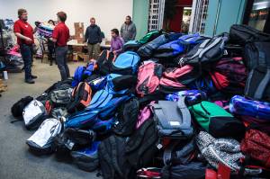 This July 2019 photo shows some of over 2,000 backpacks that were given away to students throughout Southeast Alaska through Tlingit and Haidas Temporary Assistance For Needy Families Department. This year in order to help accommodate virtual learning, when backpacks are distributed, they will come with Google Chromebooks. (Michael Penn | Juneau Empire File)