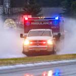 A Capital City Fire/Rescue ambulance splashes through a flooding area of Riverside Drive on their way to a call in this January 2015 photo. (Michael Penn | Juneau Empire File)