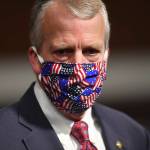 In this May 7 photo, Sen. Dan Sullivan wears a mask at a hearing in Washington. Protesters in Alaska carrying a banner and a caribou heart interrupted a campaign event for Sullivan who is seeking reelection. The Anchorage Daily News reported the small group of protesters were restrained and escorted out by staff and attendees at Sullivans campaign launch event in a hangar near Ted Stevens Anchorage International Airport, Saturday, July 11. (Kevin Dietsch/Pool via AP, File)
