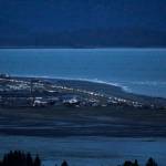 Headlights from a line of cars shine at dusk as people evacuate the Spit in Homer, Alaska, following a powerful earthquake in the Aleutian Islands that prompted a tsunami warning. There were no immediate reports of damage in the sparsely populated area of the state, and the tsunami warning was later canceled. (Pat Williams Russell)