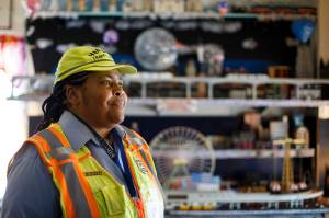 Patrice Jetter, a furloughed school crossing guard, poses for a photograph, Thursday, July 23, 2020, in Hamilton, N.J. Jetter, who has cerebral palsy and partial hearing loss, wanted to work with kids when graduating from high school. (AP Photo/Matt Slocum)