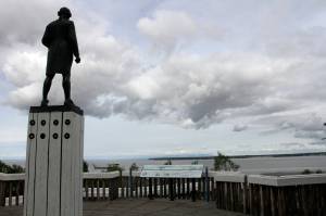 The Captain James Cook statue facing the inlet that bears his name and fronts Alaskas largest city in downtown Anchorage is seen on June 23, 2020. Far away from Confederate memorials, Alaska residents have joined the movement to eliminate statues of colonialists accused of abusing and exploiting Indigenous people. The effort has already resulted in a statue of Russian America colonialist Alexander Baranov being taken out of public view in one city. Others want statutes removed of U.S. Secretary of State and Alaska purchase architect William Seward and Capt. James Cook. (AP Photo/Mark Thiessen)