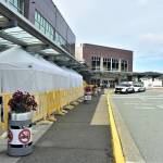 A Juneau Police Department officer at the Juneau International Airport on Tuesday, July 28, 2020. Nonresident out-of-state arrivals will have to provide negative COVID-19-test results under a revised travel mandate from Gov. Mike Dunleavy. (Peter Segall / Juneau Empire)