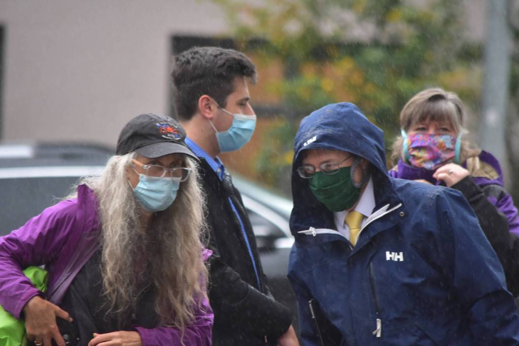 Sen. Jesse Kiehl, right, and Rep. Sara Hannan, back right, both Juneau Democrats, stepped out of their offices at the Captiol to join environmental protestors for a demonstration on the buildings steps. (Peter Segall / Juneau Empire)
