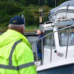 A boat pulls into Statter Harbor in Auke Bay to deliver scholarship fish or salmon caught during the derby which wont be entered into the main competition on Sunday, Aug. 16, 2020. Those fish are exchanged for raffle tickets and their holders can be awarded prizes. (Peter Segall / Juneau Empire)