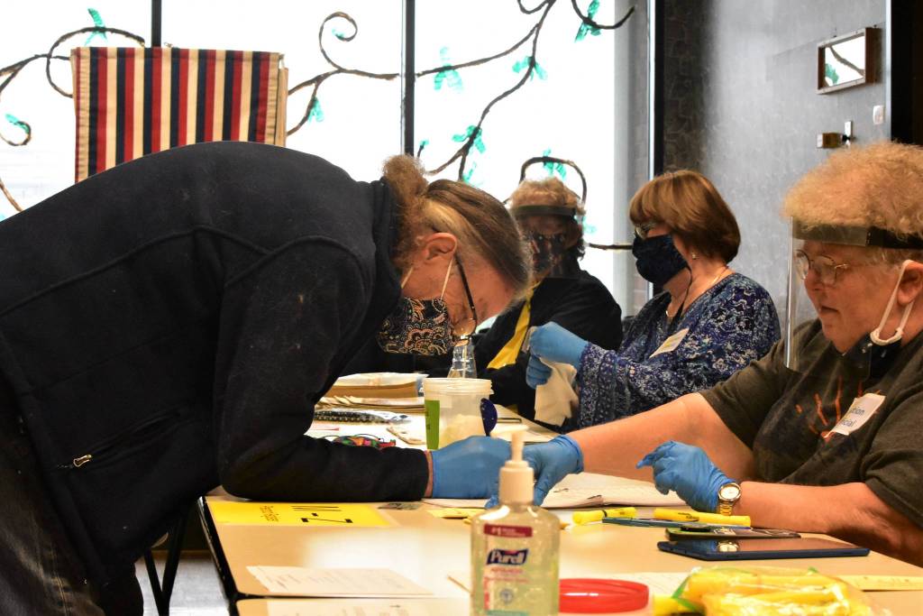 Poll worker Silvia Harvey instructs a voter at the Douglas Community Building for the 2020 Primary Election on on Tuesday, Aug. 18, 2020. (Peter Segall / Juneau Empire)
