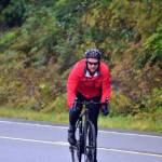 Cyclist Will Mitchell completes the first leg of the Tour of Juneau bike race on the North Douglas Highway on Friday, Aug. 14, 2020. (Peter Segall / Juneau Empire)