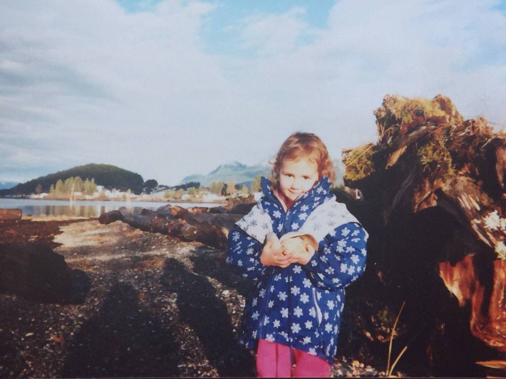 Maleah Wenzel as a child harvests from the beach. (Vivian Mork Yéilk / For the Capital City Weekly)