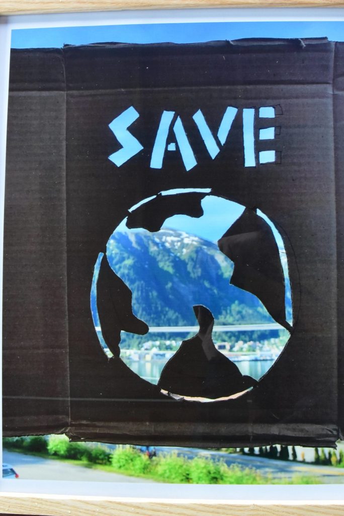 This work, submitted by an artist who wished to remain anonymous, shows a photograph of Juneau with a cardboard cut-out in front of it. (Peter Segall / Juneau Empire)