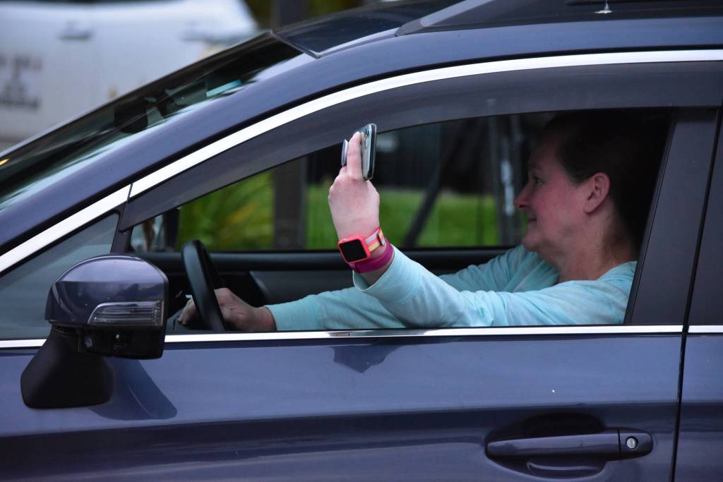 Peter Segall / Juneau Empire                                 A spectator keeps her hand on the horn, ready to honk her approval of the performance onstage at the 2020 GLITZ Drive-in Drag Show on Saturday, Aug. 29, 2020.