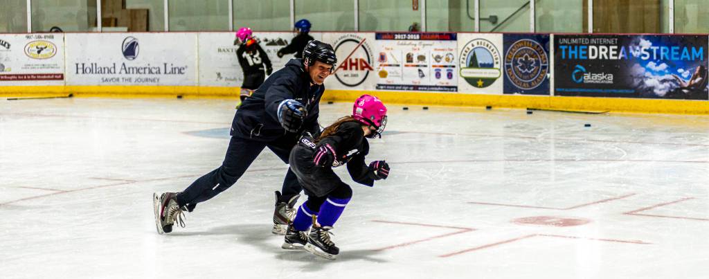 Youth hockey coach Randy Host plays freeze tag with a player competing in the 8-and-under age group. Its a favorite activity for this age group.
