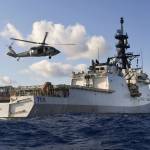 In this Aug. 25, 2020 photo provided by the U.S. Navy, an MH-60S Sea Hawk Helicopter conducts touch and go drills aboard the Legend-class cutter USCGC Munro in the Pacific Ocean. The Coast Guard cutter Munro had just embarked on a national security mission to patrol the maritime boarder between the United States and Russia in late June 2020, when one of its guardsman was diagnosed with COVID-19. Contract tracing led to more than a dozen other members of the ships crew being ordered into quarantine for two weeks. (Mass Communication Specialist 3rd Class Madysson Anne Ritter / U.S. Navy)