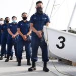 In this Monday Sept. 14, 2020 photo, From back left, Coast Guard Academy Cadets Henry Smith, Branyelle Carillo, Mia Haskovec, Jordan Park, and Tyler Huynh, pose for a photograph at the Seamanship Sailing Center at the United State Coast Guard Academy in New London, Conn. A group of Coast Guard cadets spent part of their summer filling in on a critical national security mission after a case of COVID-19 sidelined crew members on a cutter being sent to patrol the US-Russia border. (AP Photo / Jessica Hill)