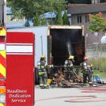 Firefighters spray the inside of a moving truck with water at the scene of a short vehicle fire on Sept. 17, 2020. (Ben Hohenstatt / Juneau Empire)